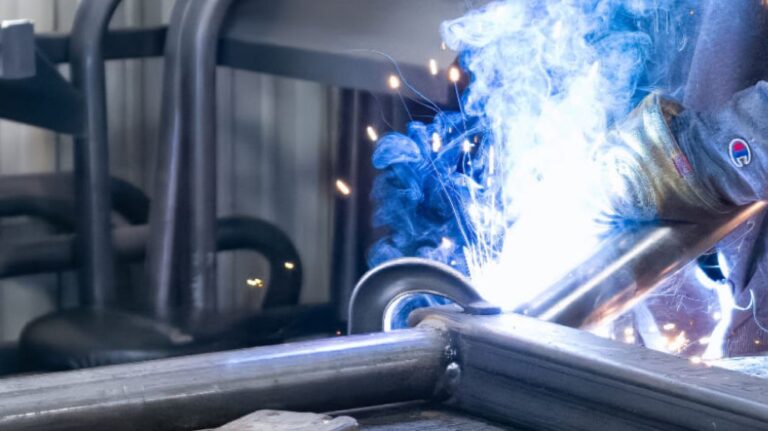 Man Welding Metal Products at P&D Metal Works