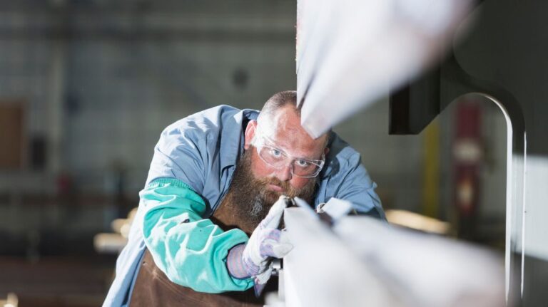 Man Looking Closely at Custom Metal Project