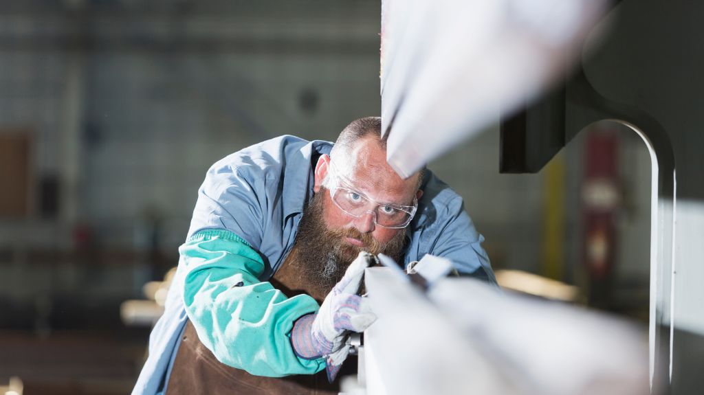 Man Looking Closely at Custom Metal Project