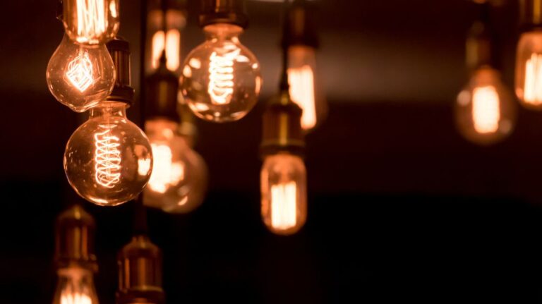 Close Up of Hanging Lit Light Bulbs in a Dark Room