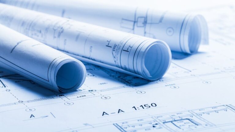 Rolled Up Blueprints on Top of a Blueprint