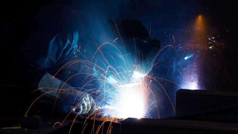 Welder Working on Steel and Throwing Sparks